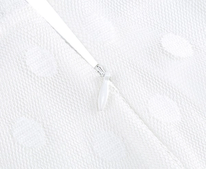 Close-up detail of invisible white zipper on retro polka dot fabric dress