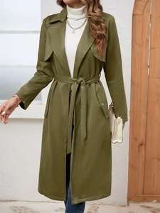 Detail view of olive green suede coat featuring classic lapels and waist belt design