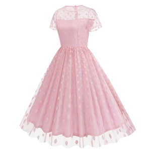 Detail of pink retro 50s Hepburn dress featuring polka dot mesh overlay and flared hem