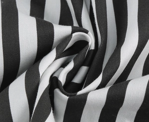 Detailed macro view of black and white striped twill fabric on a vintage Hepburn style dress