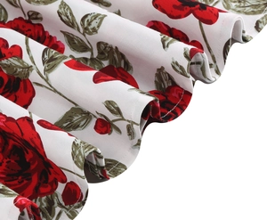 Macro detail of red rose floral print on white fabric with wave pleated hem stitch