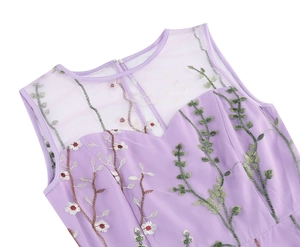 Detail of lavender dress featuring floral embroidery on semi-transparent mesh neckline