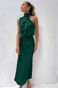 Detailed emerald green satin fabric texture and draped halter neckline on elegant dress
