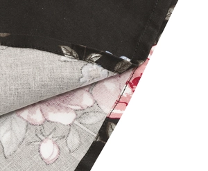 Close-up of floral print fabric showing detailed edge stitching and double-sided pattern