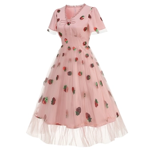 Detail of pink strawberry dress featuring sequin patterns and lace V-neckline accents