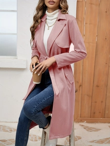 Detail of pink faux suede trench coat with notched lapels and stylish waist belt