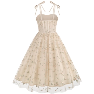 Detailed view of the bow shoulder straps and delicate floral embroidery on the tulle dress