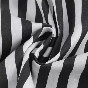 Vintage 1950s black and white striped cocktail dress with soft cotton fabric texture