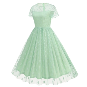 Detail of light green polka dot tulle fabric on a retro short sleeve cocktail dress