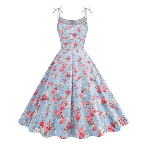 Detail of vintage 1950s floral sun dress with light blue fabric and red floral patterns