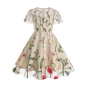 Close-up of floral embroidery on beige mesh tulle for girls summer party dress