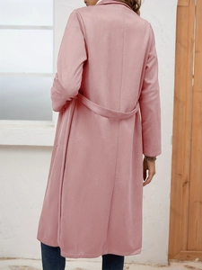 Rear view of a suede coat for women showing the elegant tailoring and waist belt design