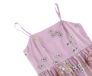 Detail of lilac cocktail dress with thin straps and delicate 3D floral embroidery