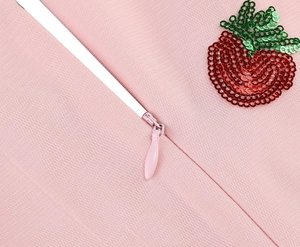 Detail of pink mesh fabric with hidden zipper and sequined strawberry applique