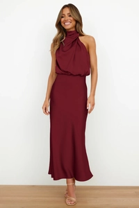 Detail of elegant burgundy satin halter dress showing smooth fabric texture and sleeveless cut