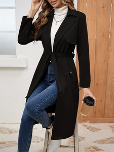 Full-length view of a long black suede trench coat with waist belt for casual commute