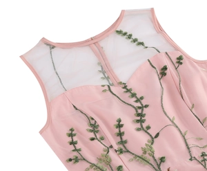 Detail of pink sleeveless dress showing sheer mesh neckline and floral vine embroidery