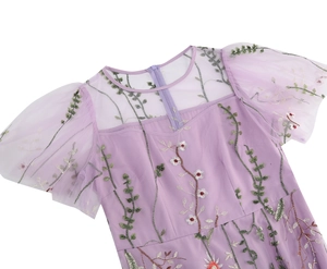 Detail of lavender mesh dress featuring intricate floral embroidery and puff sleeves