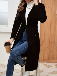 Detail view of a long black trench coat with waist tie and professional lapel design