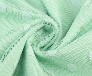 Detail of light green polka dot mesh fabric with breathable honeycomb texture