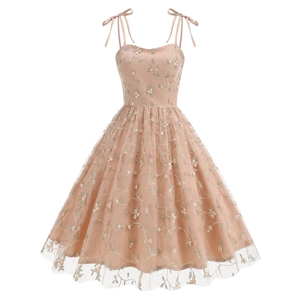 Detailed embroidery of floral patterns on pink mesh fabric of a vintage dress