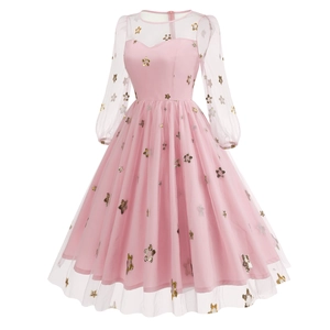 Detail of pink mesh lantern sleeves and gold star embroidery on a French evening dress
