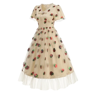 Close-up of mesh fabric featuring red strawberry sequins and delicate lace V-neck with bow