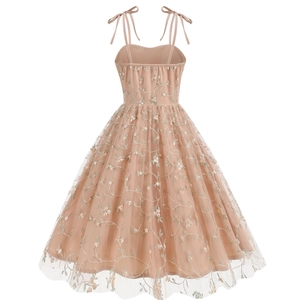 Detail of adjustable bow shoulder straps and floral embroidery on a tulle dress