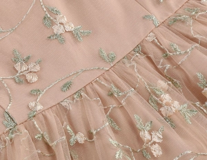 Close-up of floral embroidery on tiered mesh fabric for retro Hepburn style dress
