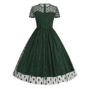 Detail of vintage dark green polka dot dress featuring mesh panel and back hidden zipper