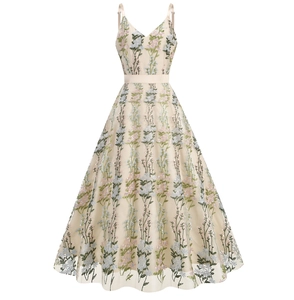 Detailed close-up of champagne tulle dress featuring colorful floral embroidery and V-neckline