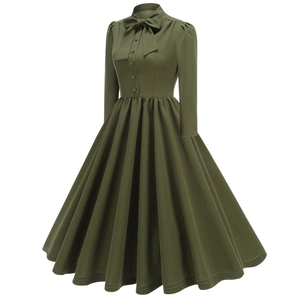 Détail d'une robe vintage vert foncé avec col à nœud et corsage boutonné sur le devant