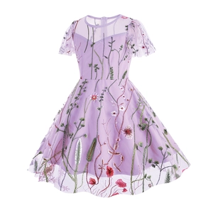 Detail of lilac tulle flower girl dress showing colorful floral embroidery and mesh sleeves