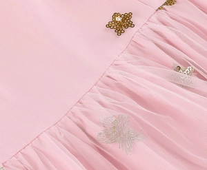 Detail of pink tulle dress with gold sequin stars and silver star embroidery craft