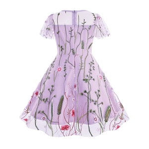 Detailed close-up of colorful floral embroidery on light purple mesh girls party dress