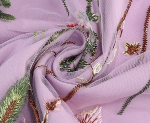 Detailed close-up of intricate plant embroidery on purple tulle mesh fabric