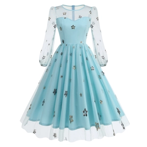 Detail of light blue mesh dress featuring gold star sequins and sheer lantern sleeves