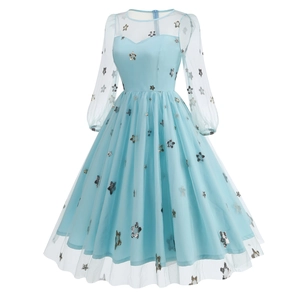 Detailed view of light blue mesh dress with silver star sequins and puff sleeves