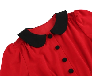 Detail of red vintage dress featuring a black Peter Pan collar and matching buttons