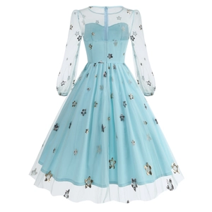 Detail view of the back zipper and gold star sequins on a light blue French dress