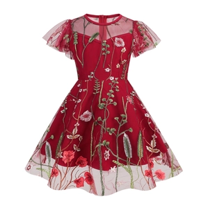 Detailed embroidery of colorful flowers on red tulle fabric for girls' party dress