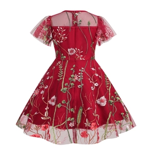 Detail of red flower embroidery and back zipper closure on girls' mesh party dress