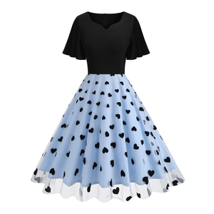 Close-up of heart neckline and ruffled cap sleeves on a 1950s mesh embroidery cocktail dress
