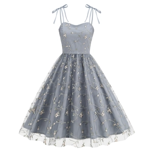 Macro shot of delicate floral embroidery on vintage mesh dress with soft tulle layering