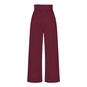 Detail of high-waist wide-leg pants in wine red with paperbag waist and matching belt