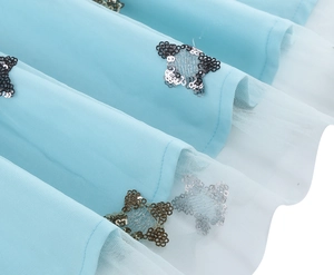 Close-up of light blue tulle dress with intricate sequin butterfly embroidery detail
