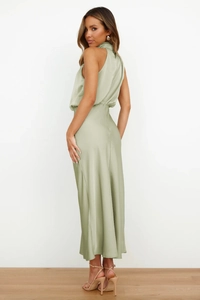 Detail view of sage green satin sleeveless maxi dress with a sleek draped back profile