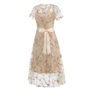 Detail of champagne mesh dress featuring delicate floral embroidery and satin waist ribbon