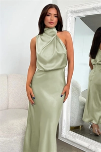 Detail of elegant sage green satin maxi dress with halter neckline and draped front texture