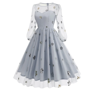 Detail of star sequin embroidery on light grey-blue tulle fairy dress with long sleeves